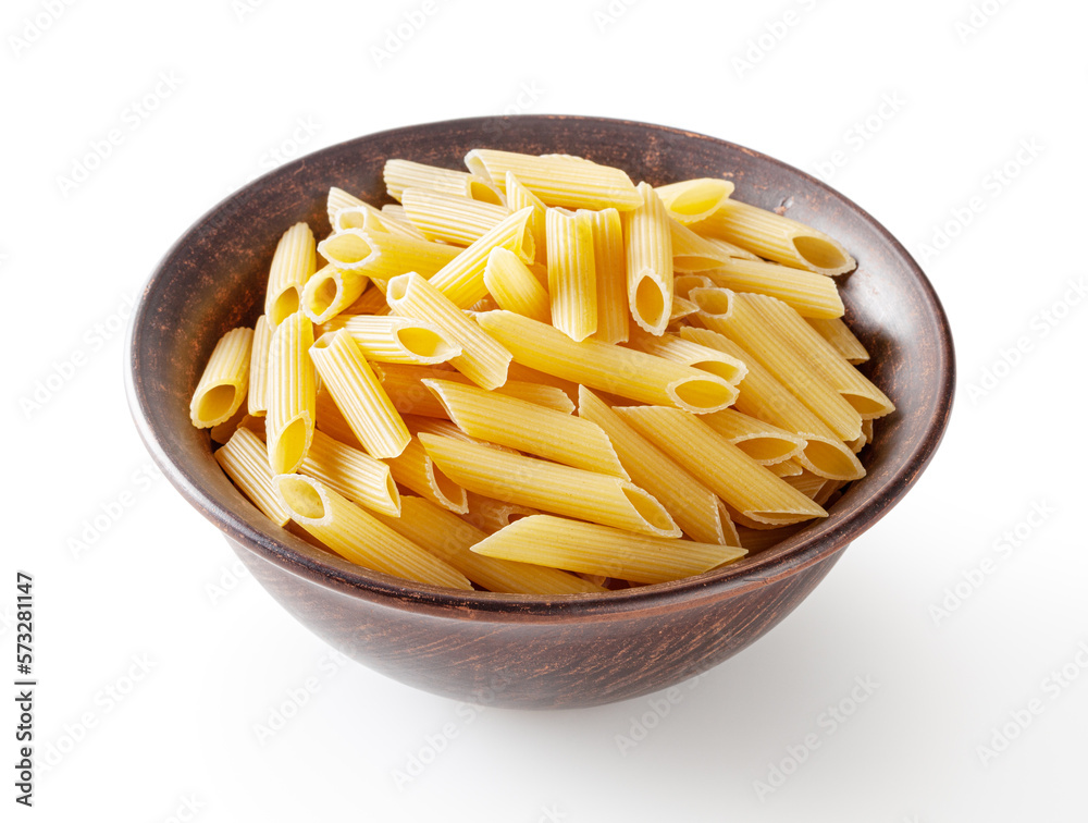 Uncooked penne pasta in ceramic bowl isolated on white background with clipping path