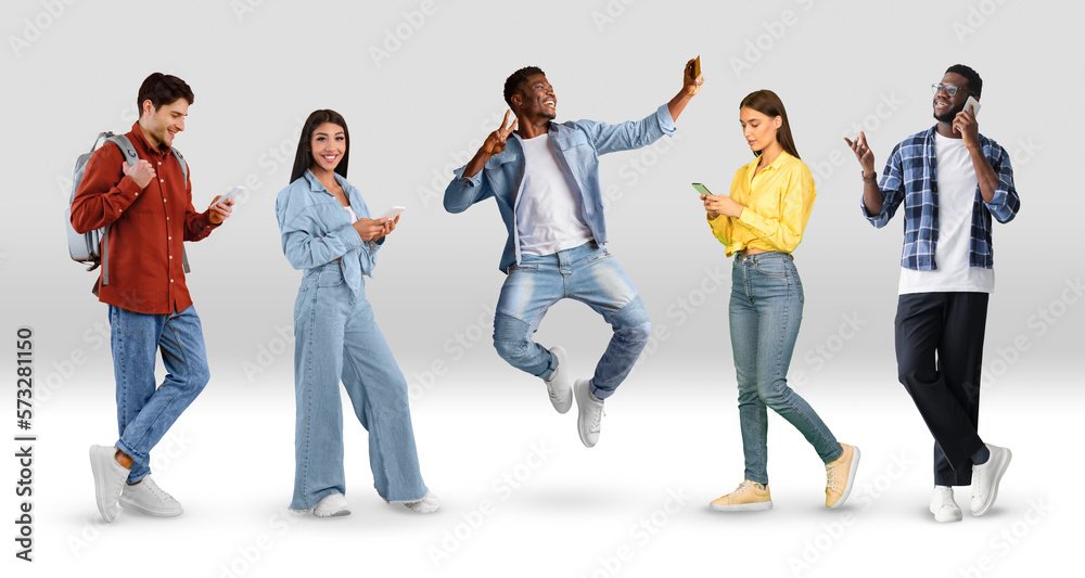 Fototapeta premium Group Of Multiethnic People Using Smartphones While Posing Over White Gradient Background