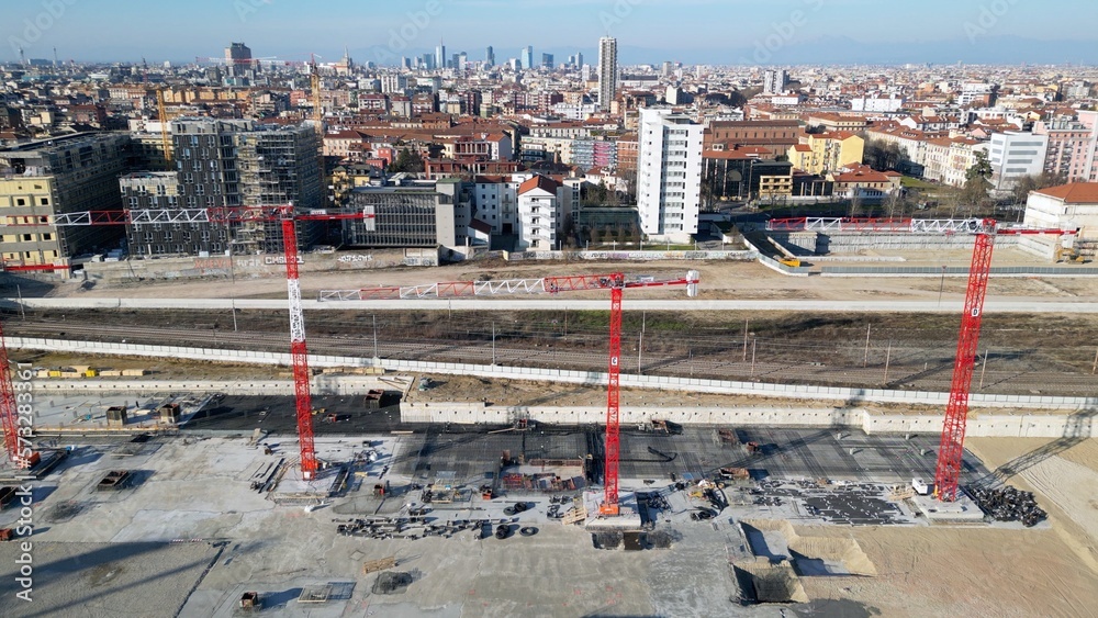 EUROPE, ITALY, MILAN 2023 - Drone aerial view of Scalo Porta Romana, building construction of Olympic Village for Milan-Cortina 2026 Winter Olympics games in downtown of the city near Prada Tower   - obrazy, fototapety, plakaty 