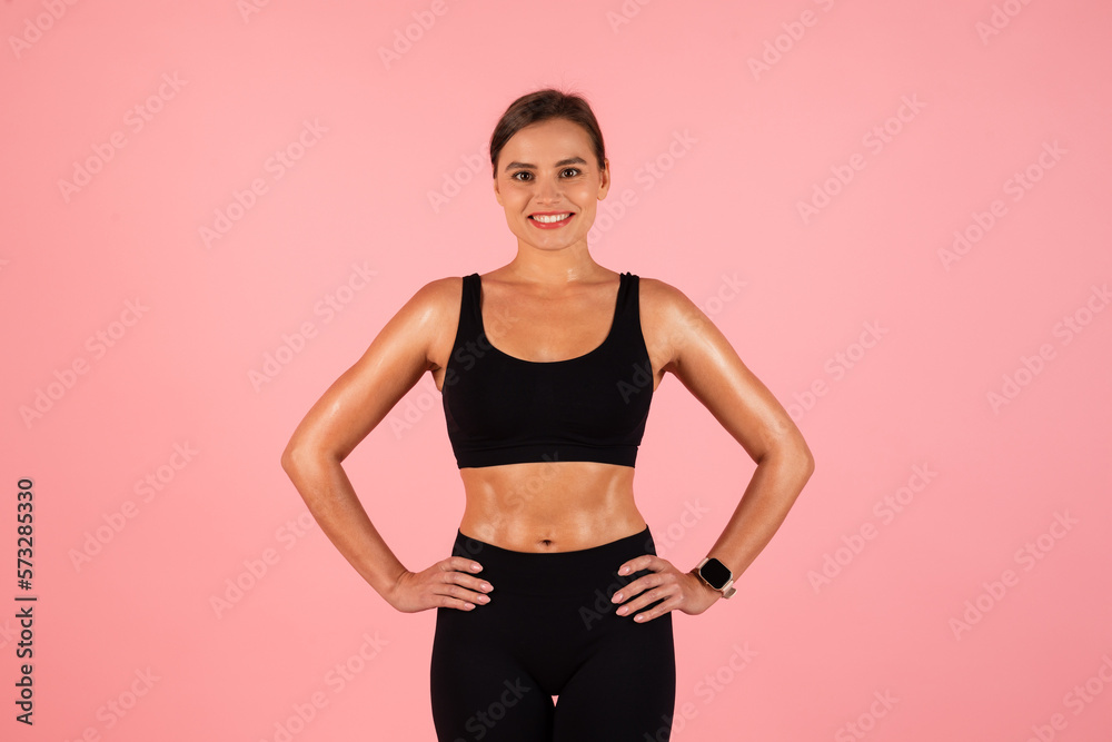 Body Shaping Concept. Smiling Young Woman In Sportswear Posing On Pink Background Body Shaping Concept. Smiling Young Woman In Sportswear Posing On Pink Background