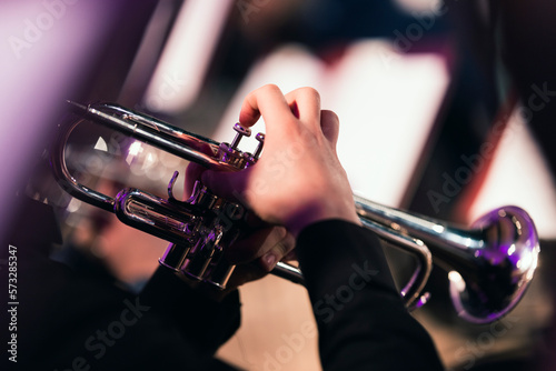 A musician playing the trumpet during an orchestra concert