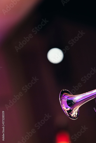Photography A shiny trumpet bell against bright stage lights during a solo of a jazz concert