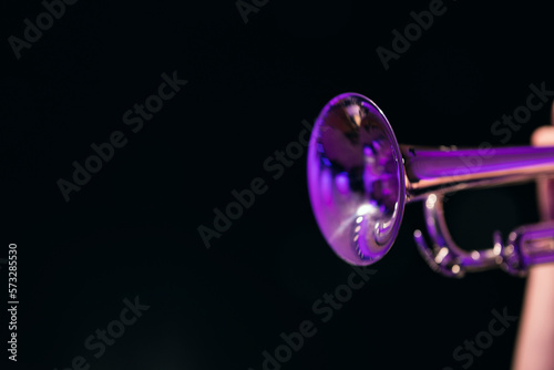 Canvas Print A shiny trumpet bell against a dark background of a performer playing a solo sur