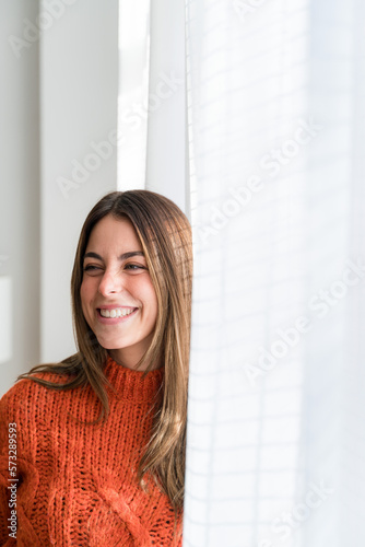 Smiling woman with long hair looking at camera