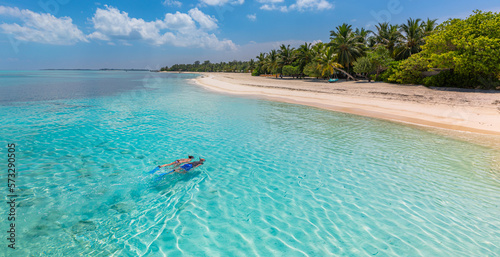 Fototapeta Naklejka Na Ścianę i Meble -  Caucasian couple of tourists snorkel in crystal turquoise water near Maldives Island. Recreational outdoor sport at luxury resort beach scene, calm sea water, couple exotic water, underwater wildlife