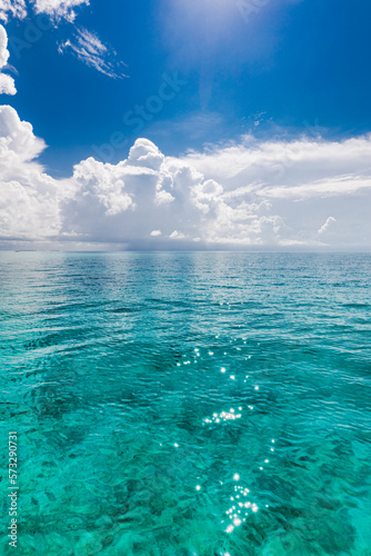 Fototapeta Naklejka Na Ścianę i Meble -  Calm sea ocean and blue sky with clouds background. Tranquil water reflection, relaxing natural scene. Exotic tropical Mediterranean sunny summer seascape. Amazing travel nautical background 