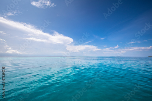 Calm sea ocean and blue sky with clouds background. Tranquil water reflection, relaxing natural scene. Exotic tropical Mediterranean sunny summer seascape. Amazing travel nautical background 