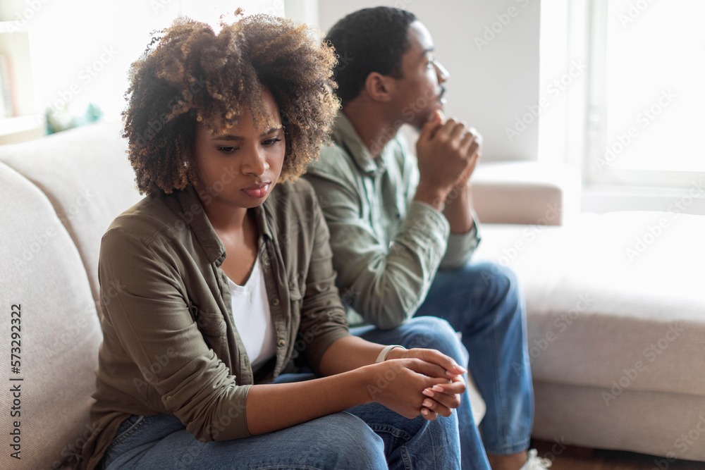 Sad african american couple sit on couch back to back Stock Photo ...