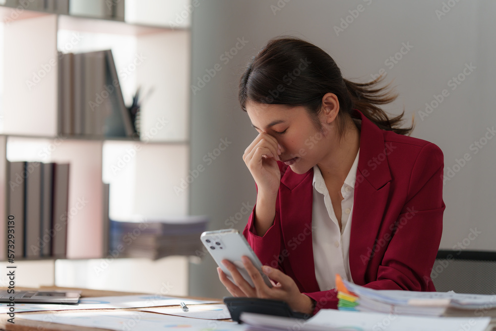 Tired business woman in stress works with many paperwork document. migraine attack. Freelance, work from home Tired business woman in stress works with many paperwork document. migraine attack. Freelance, work from home