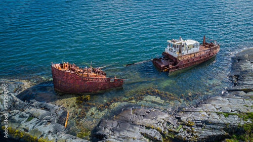 Fototapeta Naklejka Na Ścianę i Meble -  Stranded transport ship destroyed on the cliffs of a remote island after an accident