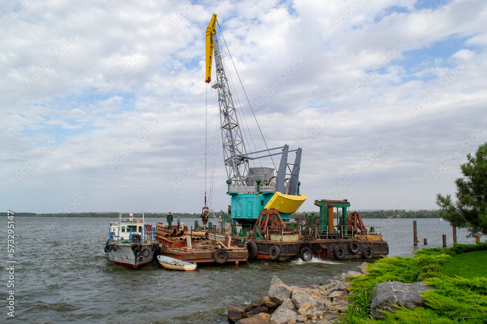 Luffing crane at the barge on water