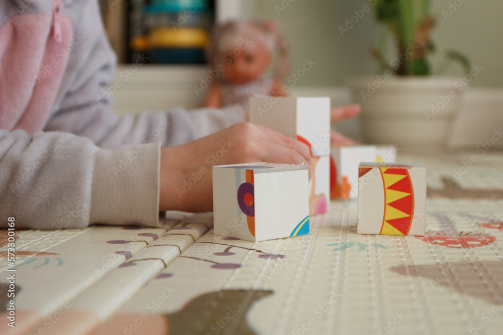 Obraz premium Little cute girl spending time in the playroom