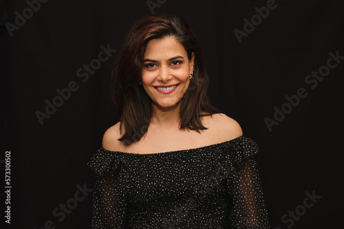Portrait of laughing woman in black strapless neckline with white polka dots