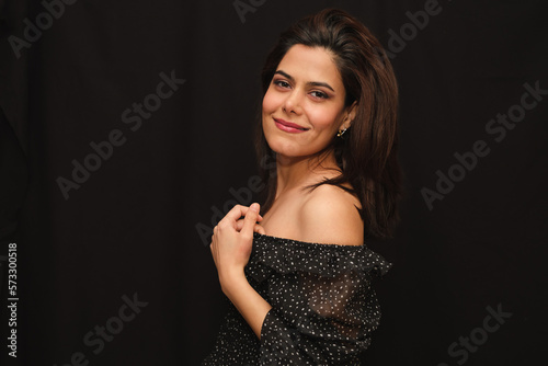 Portrait of a smiling woman with a black strapless neckline with white polka dots