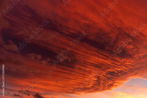 Huge orange cloud in the sky at sunset.