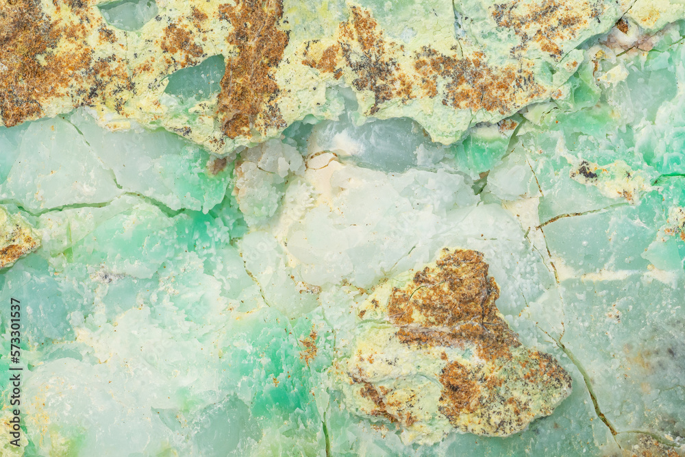 Waxy surface of Chrysoprase mineral with visible traces of nickel in apple green parts of the texture