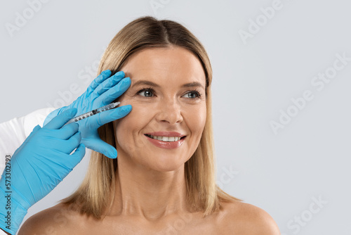 Middle aged woman gets cosmetic eye injection