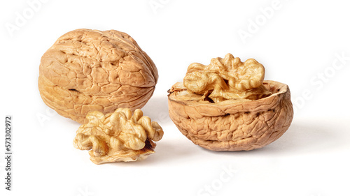 Walnuts peeled and unpeeled in the shell on white isolated background with shadow. Full depth of field