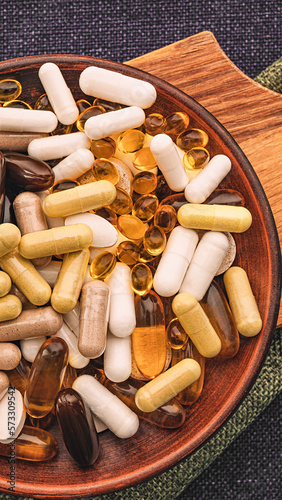 heap of pills dietary supplements vertical top view close-up. immune support medical concept