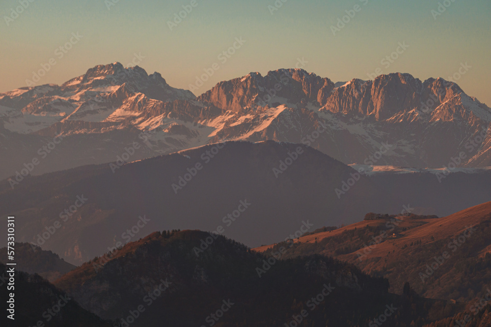 The Lombard pre-Alps near Lake Iseo, seen at sunset from one of the most beautiful viewpoints in the Province of Brescia: Punta Almana, near the town of Sale Marasino, Italy - February 2023.
