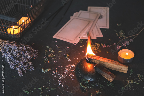 Esoteric  Occult mystical ritual scene of sorcery tarot candles  dried flowers  palo santo and tarot cards  ritual book. Witchcraft  mysticism and occultism esoteric background