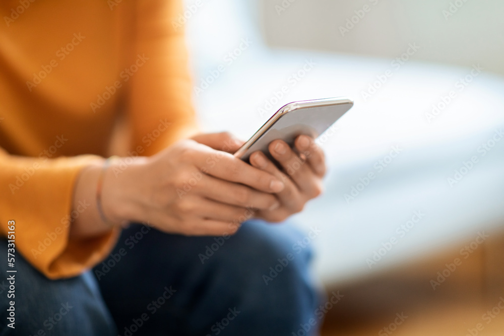 Closeup Shot Of Unrecognizable Woman Using Mobile Phone At Home Closeup Shot Of Unrecognizable Woman Using Mobile Phone At Home