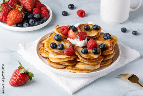 Homemade mini pancakes with blueberries, strawberries and raspberries