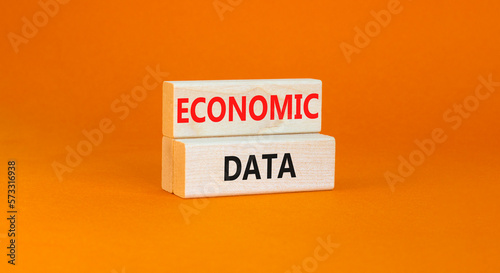 Economic data symbol. Concept words Economic data on wooden block. Beautiful orange table orange background. Business economic data concept. Copy space.