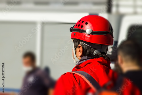 Fotobehang Unknown back of a search and rescue worker in front of blurred building