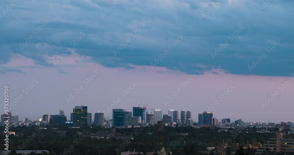 Cityscape sunset time lapse. The silhouettes of skyscrapers and urban buildings against the background of clouds. City modern intensive life. Cityscape sunset time lapse. The silhouettes of skyscrapers and urban buildings against the background of clouds. City modern intensive life.