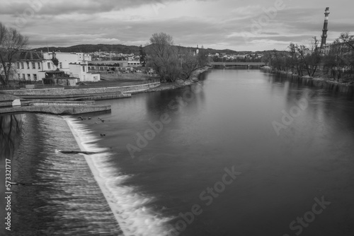 River Otava and weir with footbridge near Pisek town in south Czech in evening photo