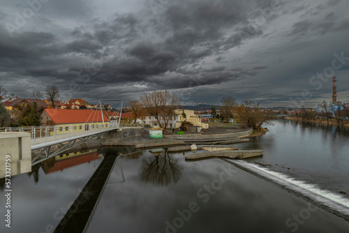 River Otava and weir with footbridge near Pisek town in south Czech in evening