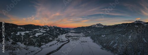 Sunset panoramic view of the top of Waidegg near Tressdorf on the border between Italy and Austria. Nassfeld ski resort in 5km. January 2022, drone aerial shot.