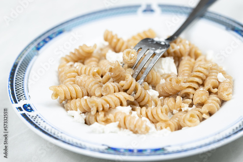 Macaroni pasta with cheese served in the plate with closesup macro shots