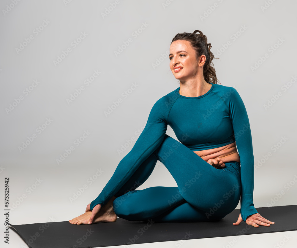 A beautiful woman is exercising in a yoga class for weight loss A beautiful woman is exercising in a yoga class for weight loss