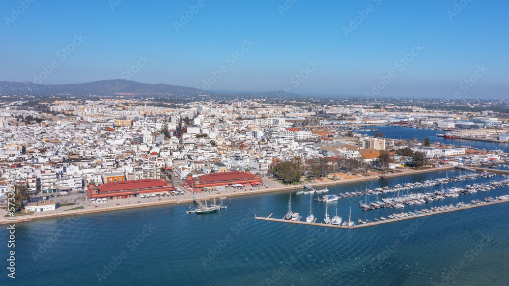 Aerial view of the Portuguese fishing tourist town of Olhao overlooking the Ria Formosa Marine Park. sea port for yachts and Municipal market