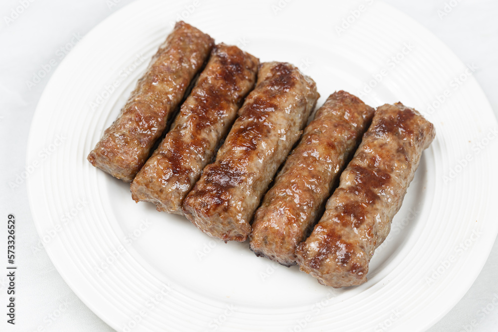 Fresh baked kebabs with minced meat served on the plate