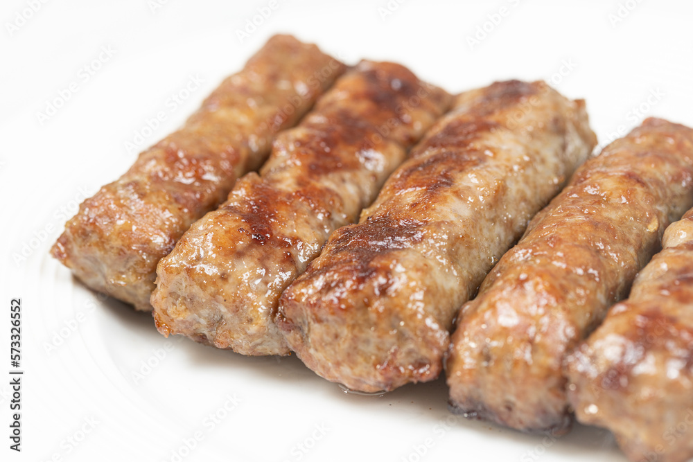 Fresh baked kebabs with minced meat served on the plate Fresh baked kebabs with minced meat served on the plate