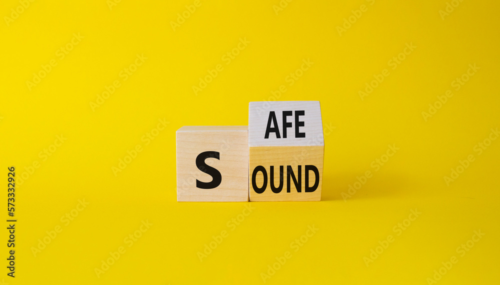 Safe and Sound symbol. Turned wooden cubes with words Safe and Sound. Beautiful yellow background. Business and Safe and Sound concept. Copy space Safe and Sound symbol. Turned wooden cubes with words Safe and Sound. Beautiful yellow background. Business and Safe and Sound concept. Copy space