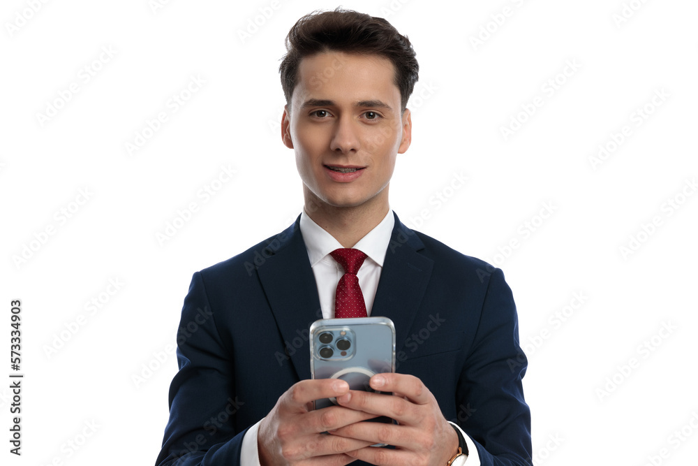 businessman texting on his phone and smiling businessman texting on his phone and smiling