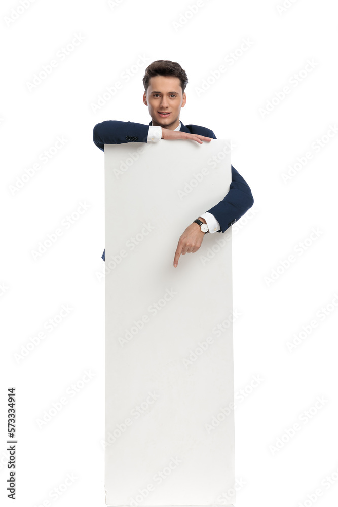 businessman presenting billboard and pointing down businessman presenting billboard and pointing down
