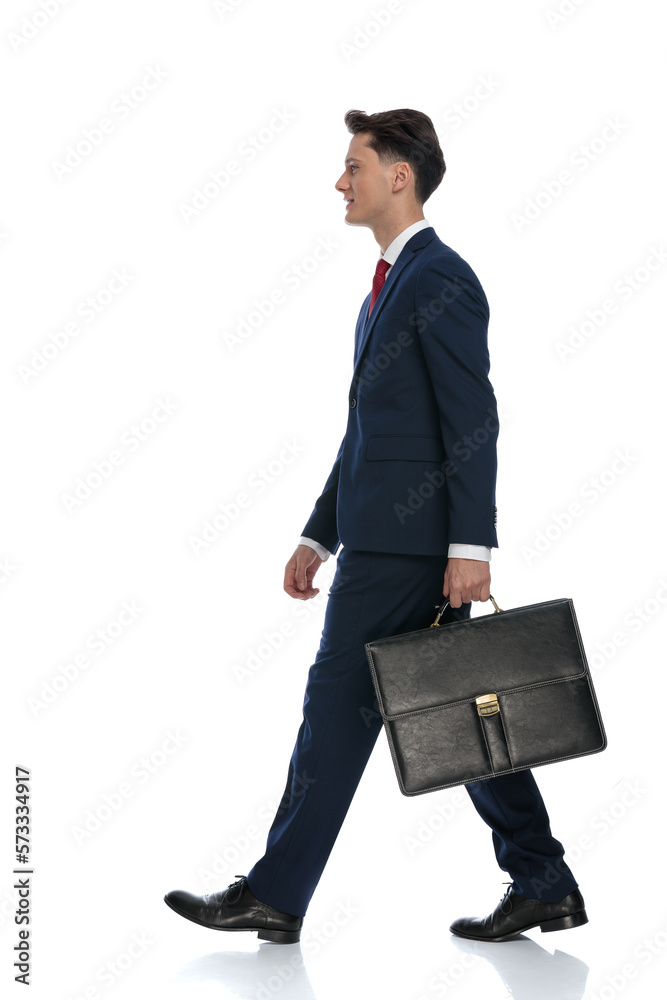 businessman walking and holding a briefcase businessman walking and holding a briefcase