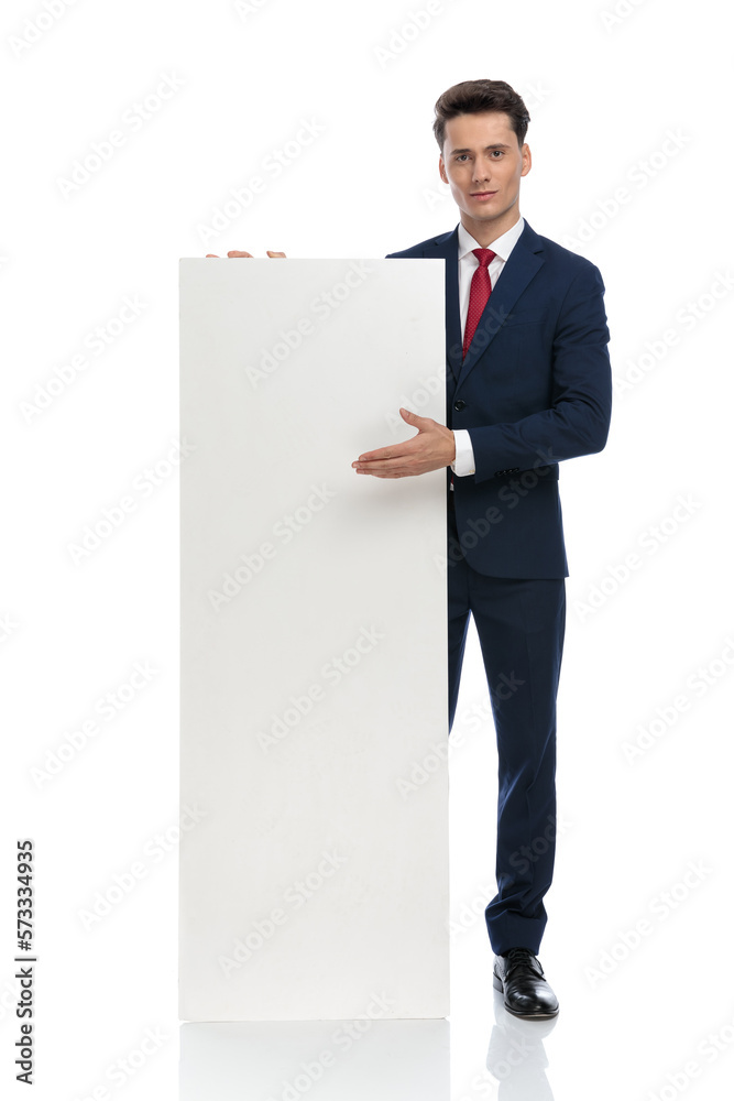 businessman presenting billboard and looking at camera businessman presenting billboard and looking at camera