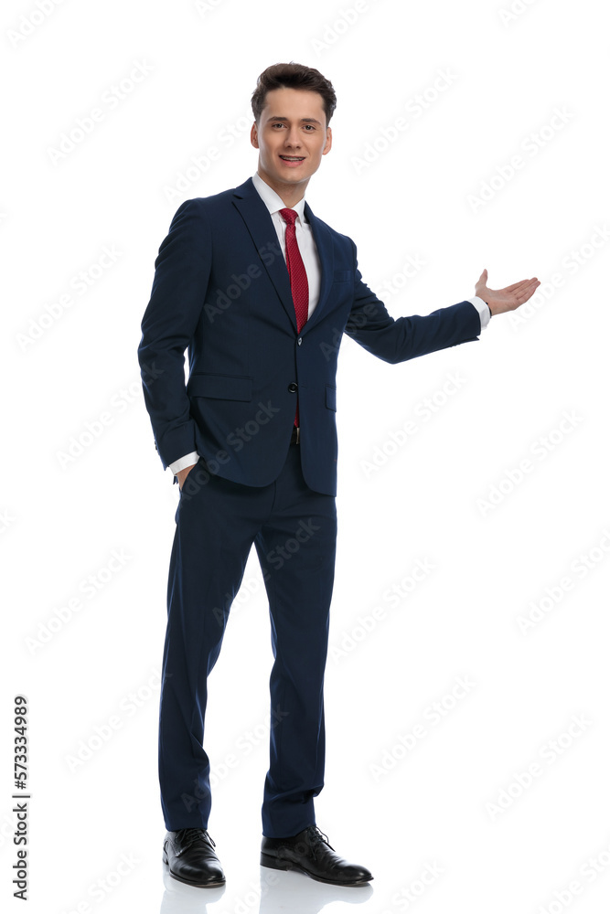 businessman pointing to the side with hand in pocket businessman pointing to the side with hand in pocket