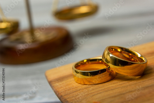 Divorce concept. Law and Justice background. Judge gavel on with two golden wedding rings