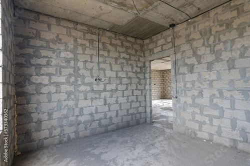 Construction of an individual residential building, view of the corner of the room, one of the walls with a doorway