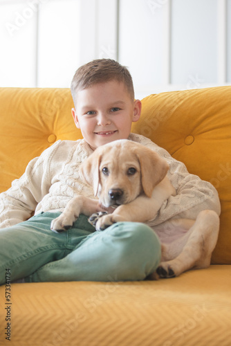 Little boy and his labrador puppy