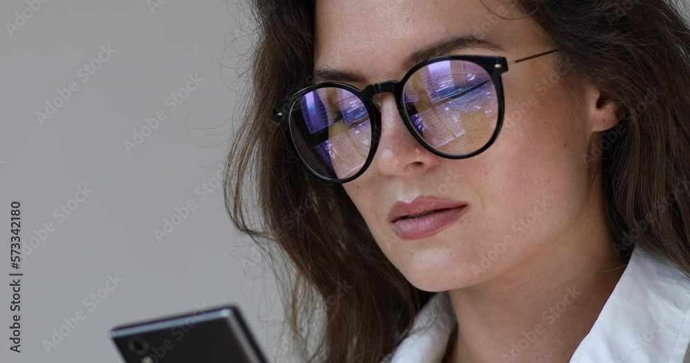 Businesswoman in eyeglasses talking by smartphone Businesswoman in eyeglasses talking by smartphone