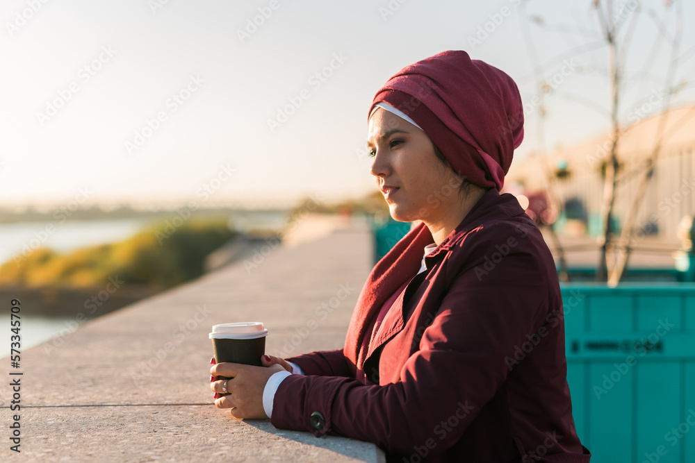 Portrait arab woman in hijab drinking coffee in cafe outdoors, copy space and empty place for advertising