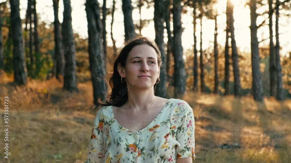 Video of happy young woman walking in pine forest during sunset and relaxing. Video of happy young woman walking in pine forest during sunset and relaxing.